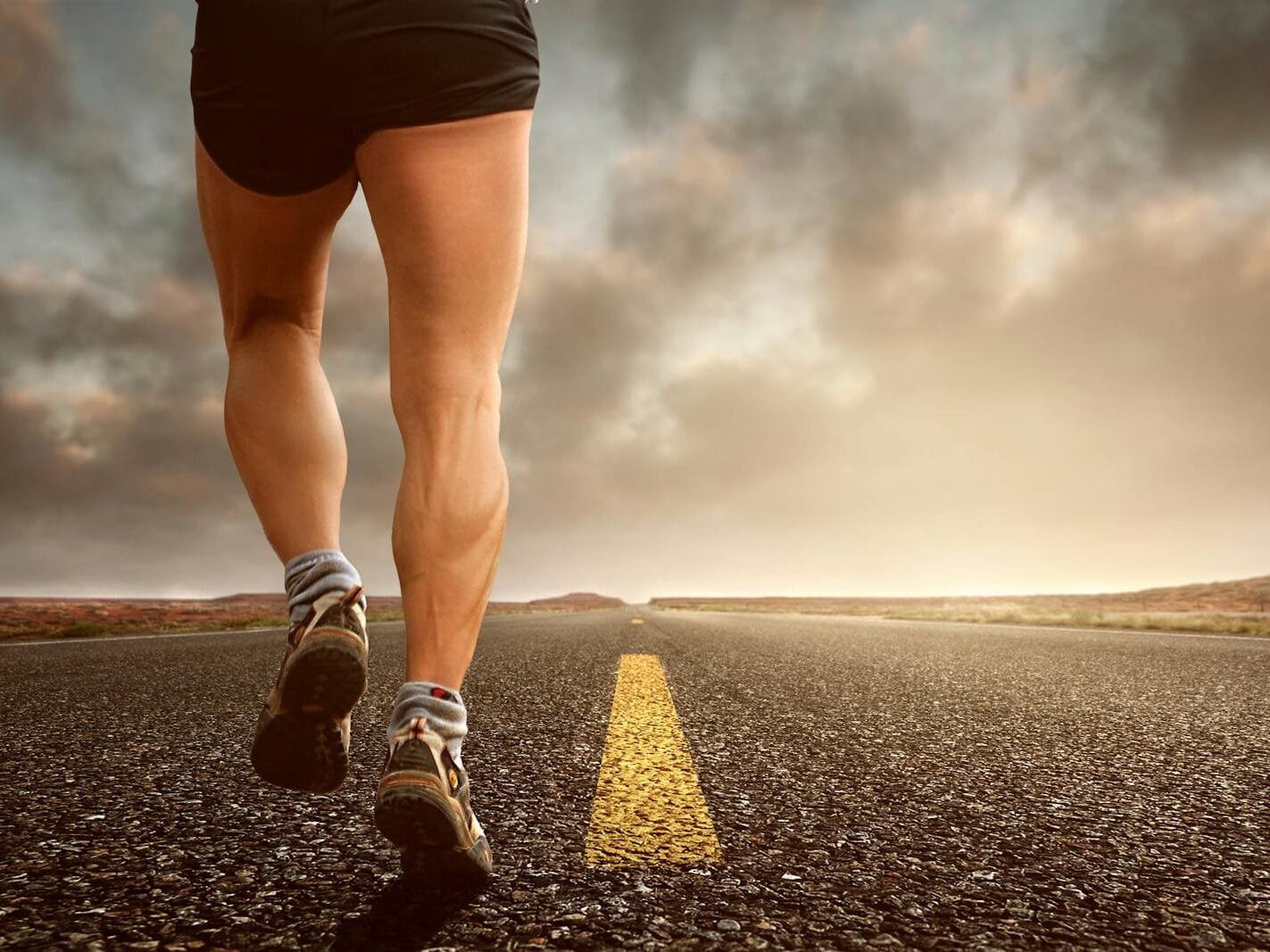 How Can I Lower Blood Sugar Quickly? A Friendly Guide Runner's legs on a road during a sunset, symbolizing endurance and outdoor fitness training.