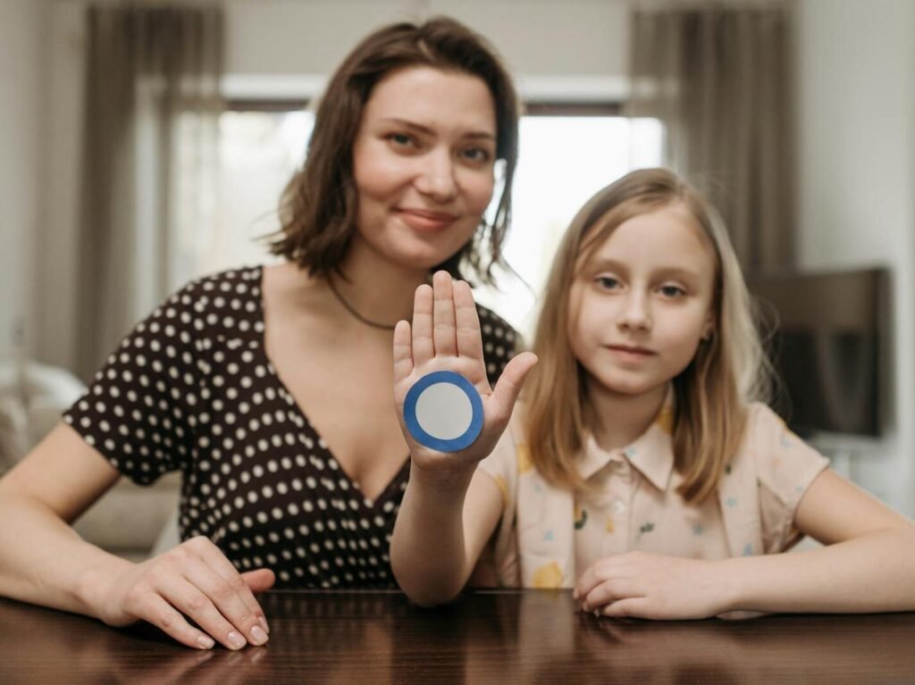 What Is Type 2 Diabetes? Causes, Symptoms And Treatment A mother and daughter raise awareness for diabetes with a blue circle symbol indoors.